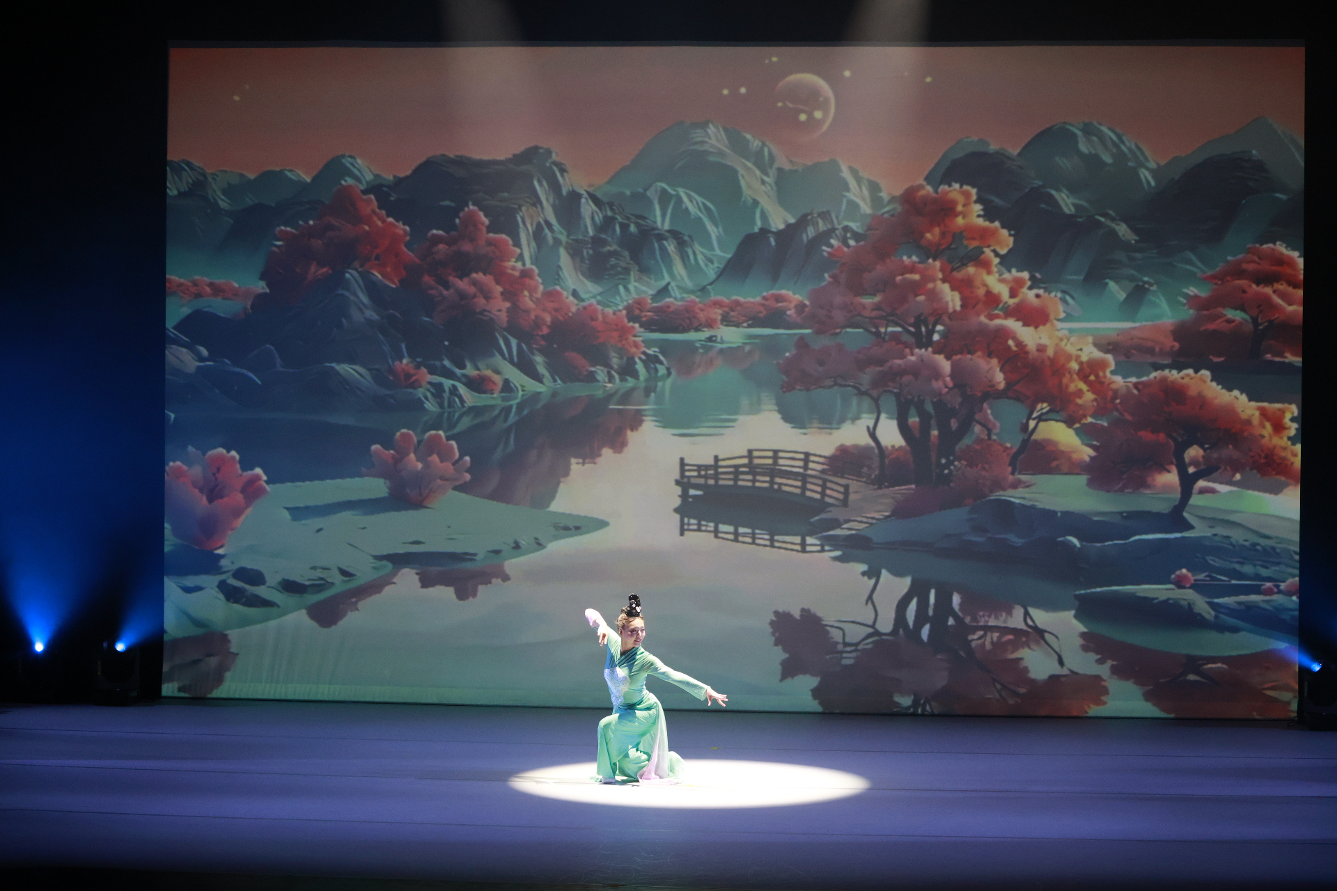 Classical solo before a mountain-and-lake scenic backdrop